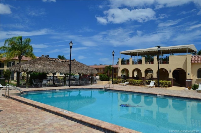 community pool featuring a patio and fence