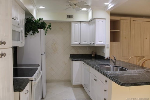 kitchen with visible vents, crown molding, white cabinets, white appliances, and a sink