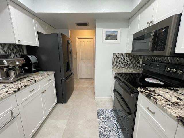 kitchen with tasteful backsplash, white cabinetry, and black appliances