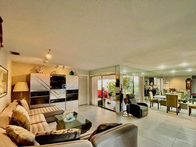 living room with visible vents and light tile patterned floors