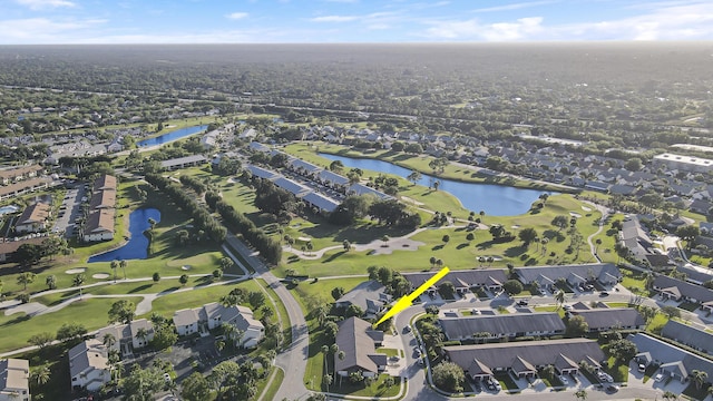 drone / aerial view featuring a residential view and a water view