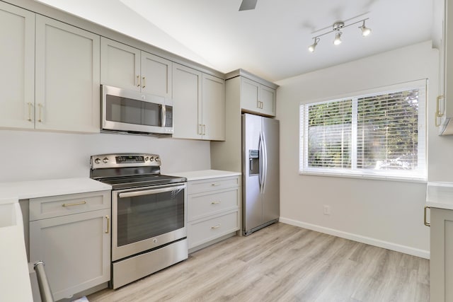 kitchen with light wood-style floors, appliances with stainless steel finishes, gray cabinets, and light countertops