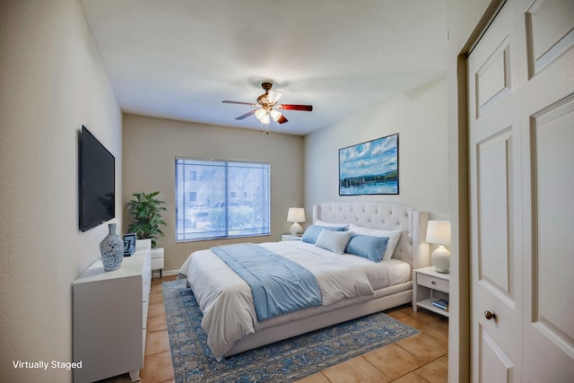 bedroom featuring light tile patterned flooring and ceiling fan