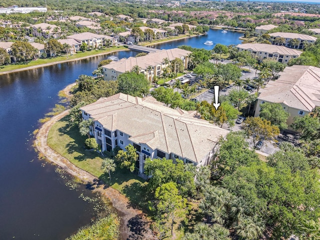 aerial view of residential area featuring a large body of water