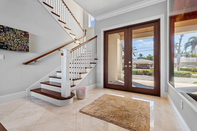 entrance foyer with french doors, stairs, baseboards, and crown molding