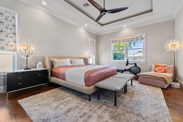 bedroom with visible vents, crown molding, recessed lighting, a raised ceiling, and dark wood-style flooring
