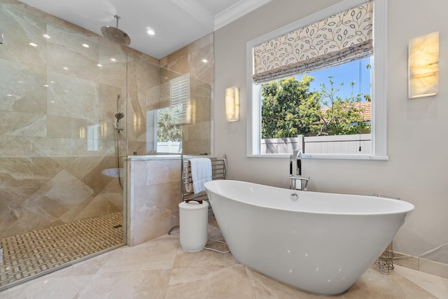 full bathroom featuring ornamental molding, tiled shower, a wealth of natural light, and a freestanding bath