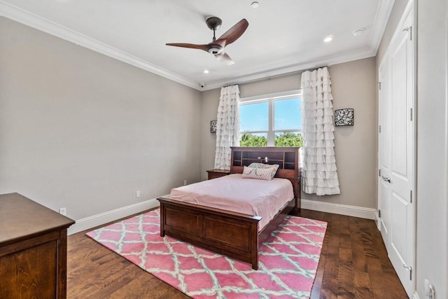 bedroom featuring crown molding, baseboards, and wood finished floors