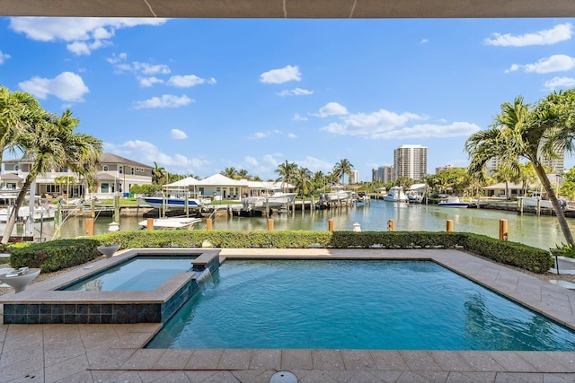 view of pool with a water view, a dock, and a pool with connected hot tub