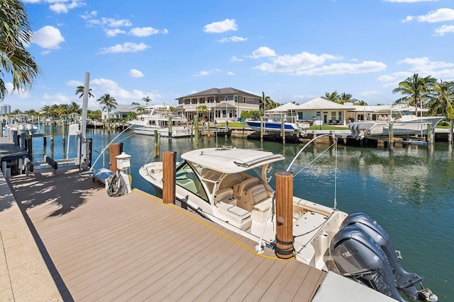 view of dock featuring boat lift, a residential view, and a water view