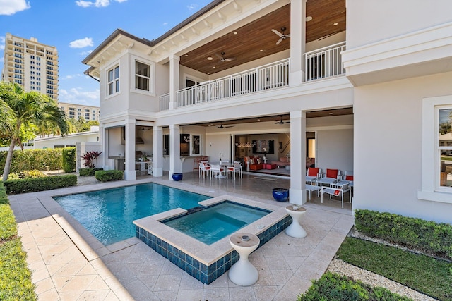 back of property with a balcony, stucco siding, a patio, and ceiling fan