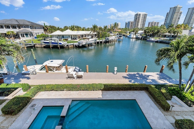 exterior space featuring a city view, a pool with connected hot tub, a dock, and a water view