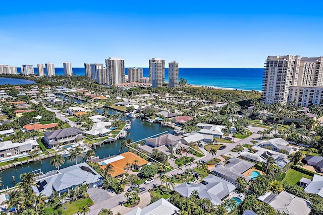 birds eye view of property with a city view and a water view