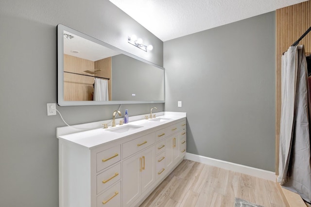 3558 SW Pisano St, Port Saint Lucie, FL 34953 - full bathroom featuring a sink, baseboards, wood finished floors, and double vanity