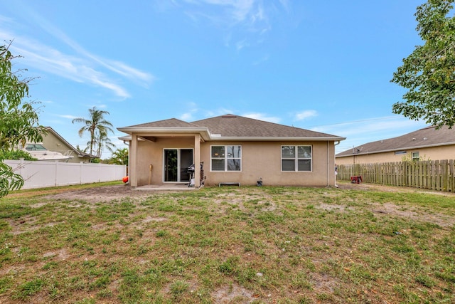 3558 SW Pisano St, Port Saint Lucie, FL 34953 - rear view of property featuring a yard, a fenced backyard, and stucco siding
