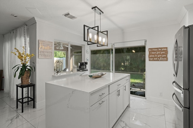 kitchen with visible vents, freestanding refrigerator, white cabinetry, crown molding, and marble finish floor