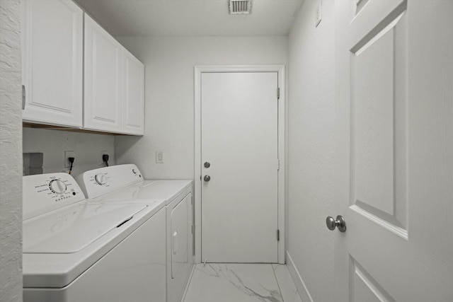 clothes washing area featuring visible vents, marble finish floor, baseboards, cabinet space, and independent washer and dryer