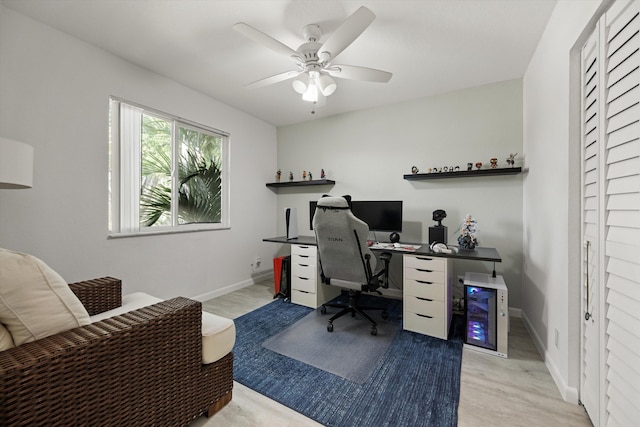 home office with baseboards, a ceiling fan, and wood finished floors