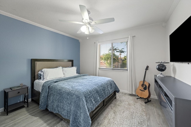 bedroom with ceiling fan, baseboards, light wood-style floors, and ornamental molding