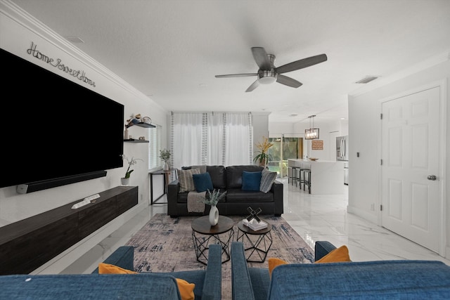 living room with ornamental molding, visible vents, marble finish floor, and ceiling fan