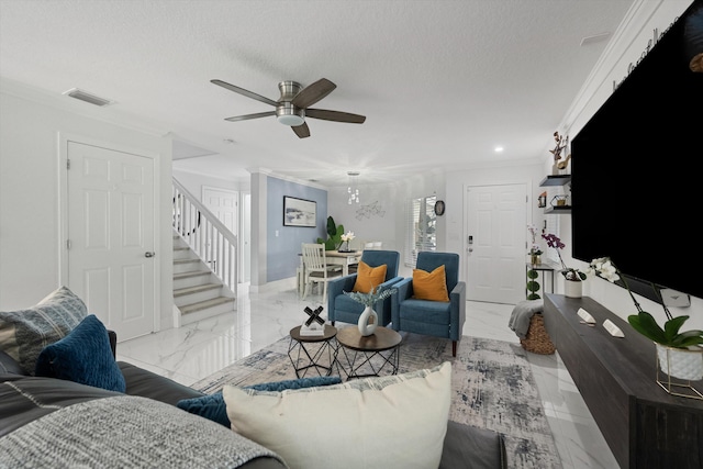 living area with stairs, ornamental molding, marble finish floor, and ceiling fan