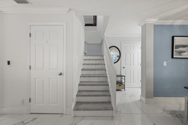 staircase with baseboards, marble finish floor, and ornamental molding