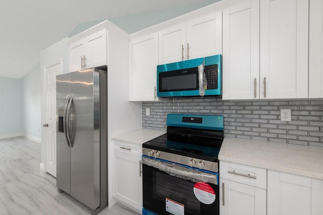 3897 NW 19th Ave, Okeechobee, FL 34972 - kitchen with white cabinets, tasteful backsplash, and appliances with stainless steel finishes