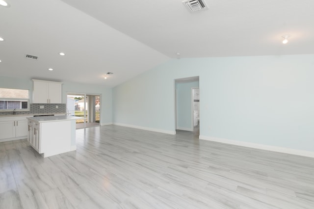 3897 NW 19th Ave, Okeechobee, FL 34972 - kitchen featuring visible vents, baseboards, open floor plan, and light countertops