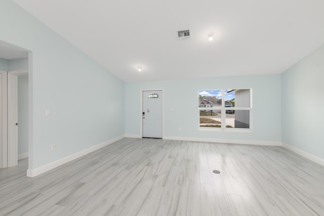 3897 NW 19th Ave, Okeechobee, FL 34972 - unfurnished living room with light wood finished floors, visible vents, and baseboards