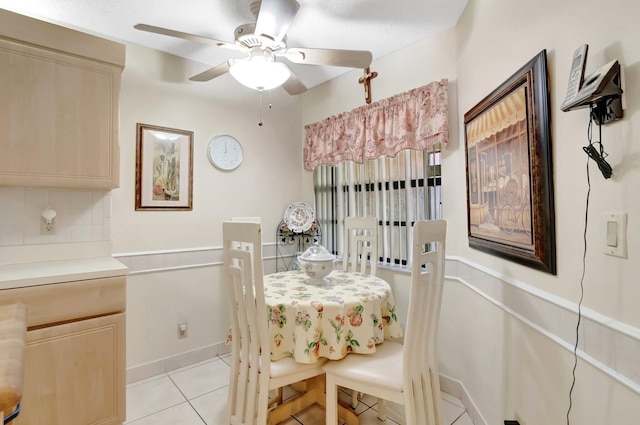dining space featuring light tile patterned floors, baseboards, and ceiling fan