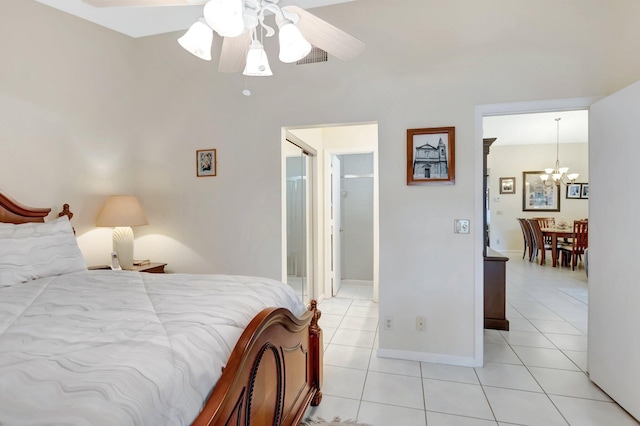 bedroom with light tile patterned floors, baseboards, and ceiling fan with notable chandelier