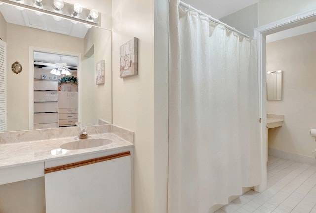 full bath with vanity, a shower with shower curtain, a closet, and tile patterned flooring