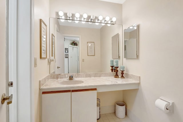 bathroom featuring tile patterned flooring, vanity, and baseboards