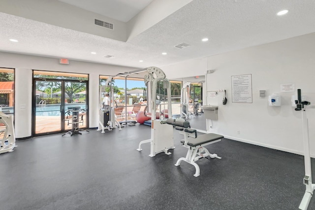 gym with recessed lighting, baseboards, visible vents, and a textured ceiling