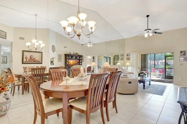 dining area with light tile patterned floors, visible vents, ceiling fan with notable chandelier, and high vaulted ceiling
