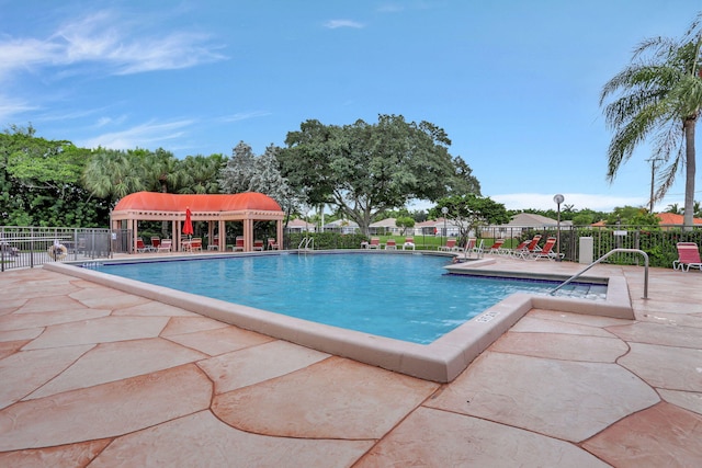 community pool featuring a patio area and fence