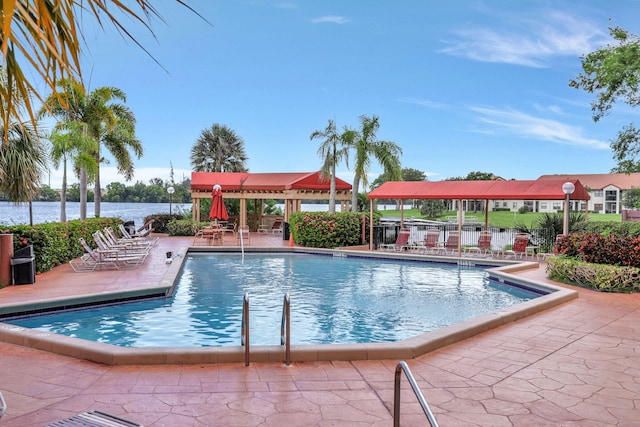 community pool with a patio and a water view