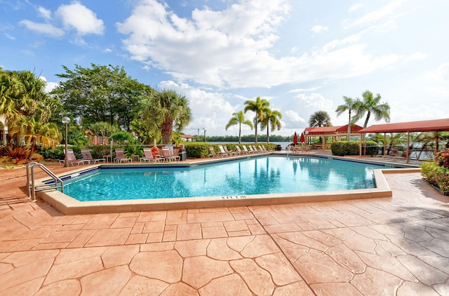 pool featuring a patio area and fence