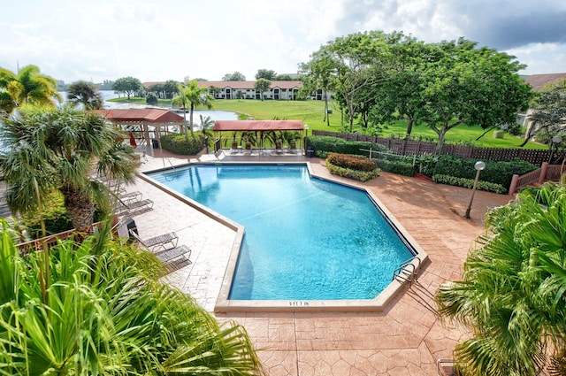 community pool featuring a patio area and fence