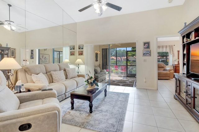 living room featuring baseboards, light tile patterned flooring, and a ceiling fan