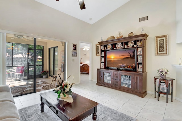 living room with light tile patterned floors, visible vents, high vaulted ceiling, and a ceiling fan