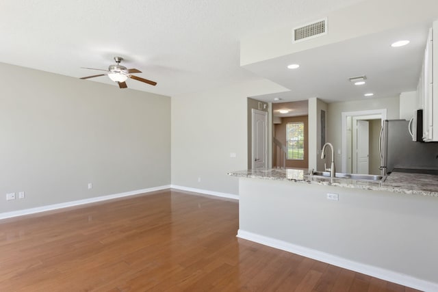 155 Waterford Dr, Jupiter, FL 33458 - kitchen with white cabinets, a peninsula, a sink, ceiling fan, and dark wood-style floors