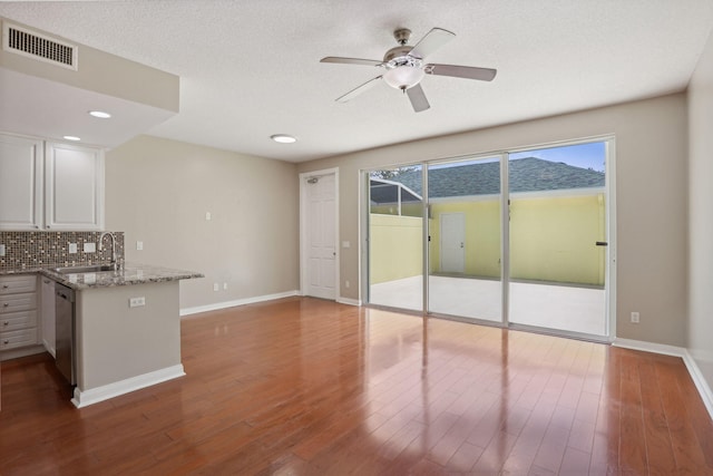 155 Waterford Dr, Jupiter, FL 33458 - kitchen featuring a sink, dishwasher, a ceiling fan, a peninsula, and backsplash