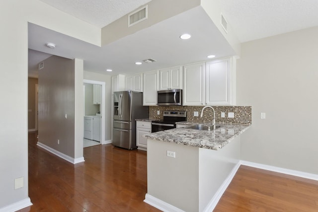 155 Waterford Dr, Jupiter, FL 33458 - kitchen with appliances with stainless steel finishes, a sink, dark wood-type flooring, white cabinets, and recessed lighting