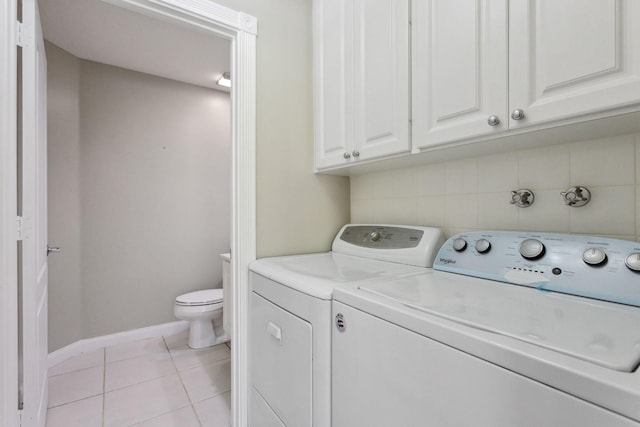 155 Waterford Dr, Jupiter, FL 33458 - washroom with washing machine and clothes dryer, light tile patterned floors, baseboards, and cabinet space