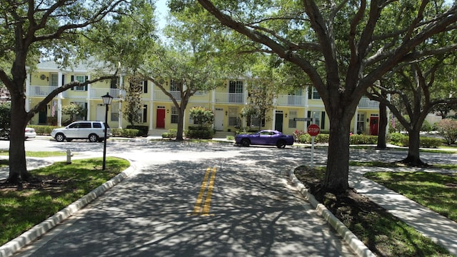 155 Waterford Dr, Jupiter, FL 33458 - view of asphalt road featuring curbs, traffic signs, and sidewalks