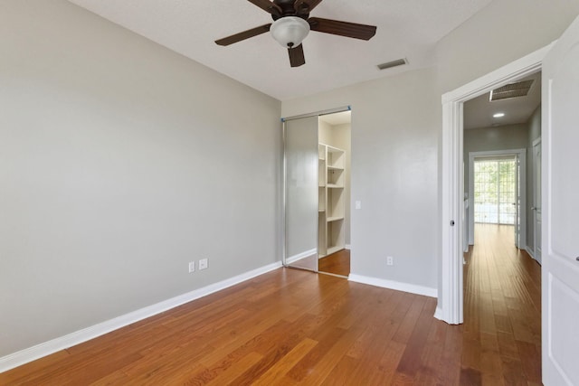 155 Waterford Dr, Jupiter, FL 33458 - unfurnished bedroom featuring wood finished floors, baseboards, a closet, and ceiling fan