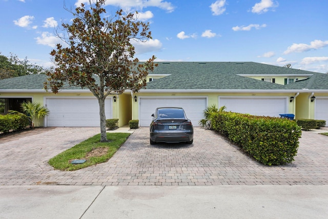 155 Waterford Dr, Jupiter, FL 33458 - view of front of property featuring decorative driveway, a shingled roof, and stucco siding
