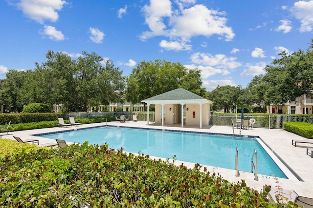 155 Waterford Dr, Jupiter, FL 33458 - community pool featuring fence, a patio area, and view of wooded area