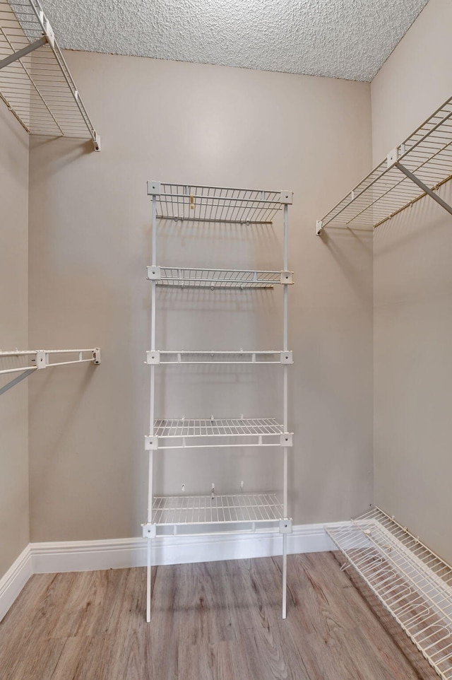 7300 Amberly Ln Unit 101, Delray Beach, FL 33446 - walk in closet with wood finished floors